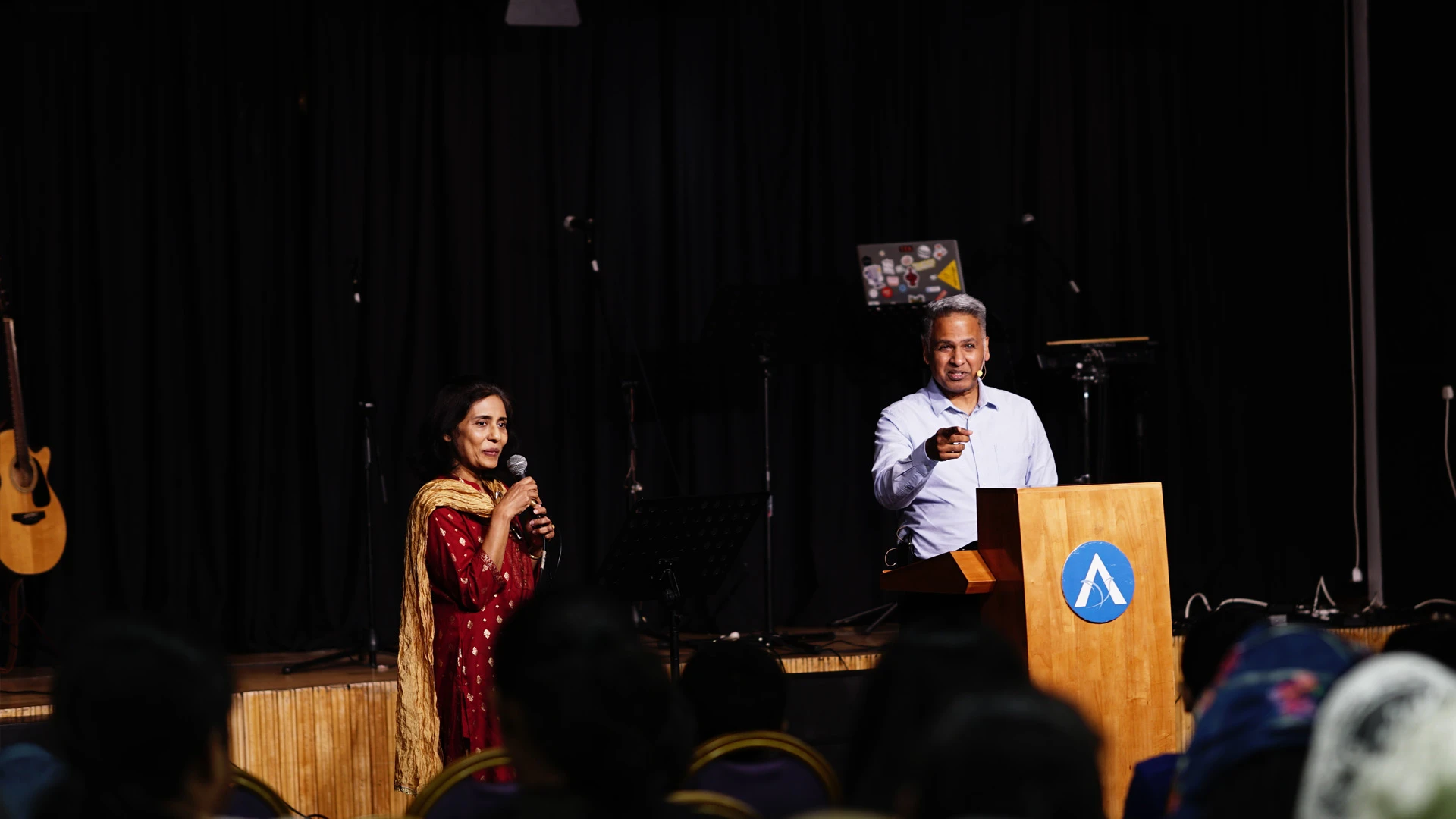The ALF Kuwait congregation standing in worship during a Friday service.