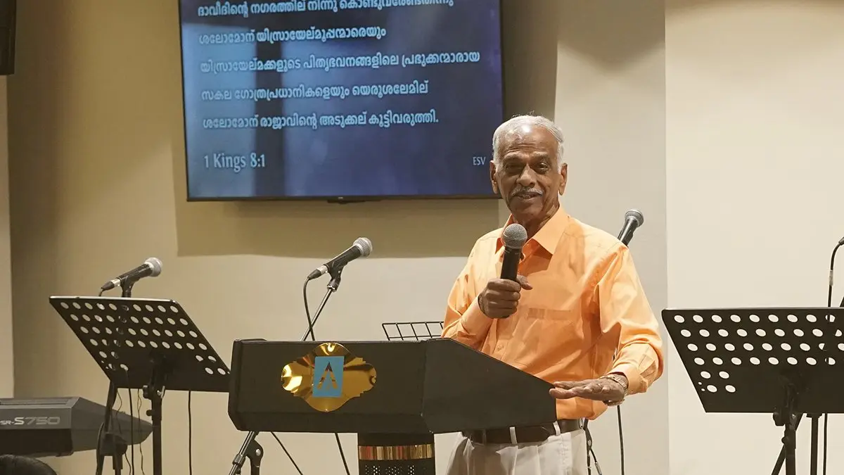 Pastor John Mathew preaching from the pulpit at Abundant Life Fellowship, Kuwait.